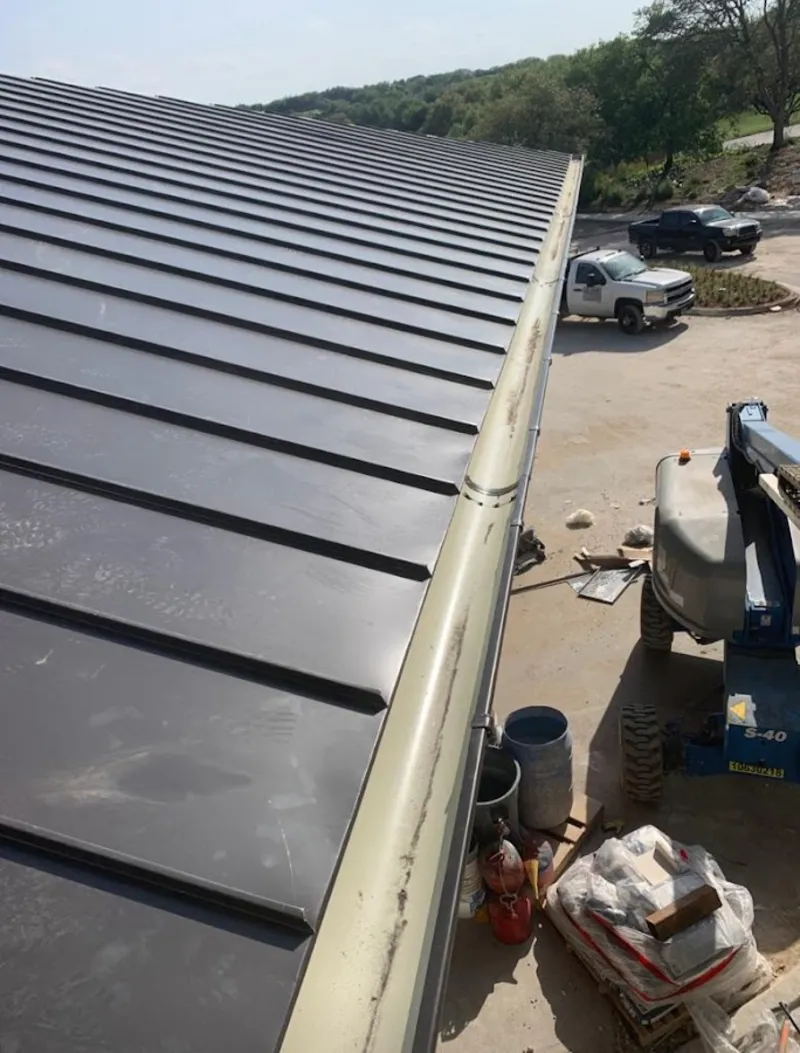 Standing seam panel and gutter detail on a metal roofing jobsite in Lebanon